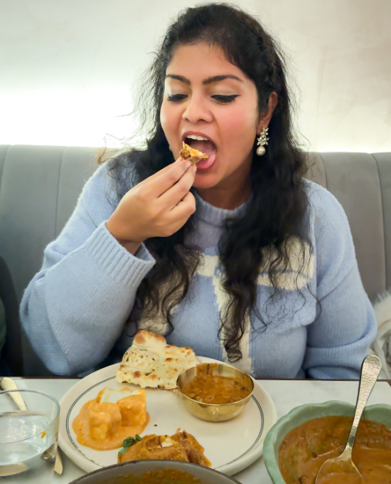 eating the delicious Indian food in bungalow in nyc