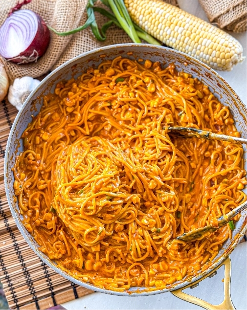 finished cheesy spicy corn noodles with cheese mixed in, ready to serve