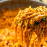 Cheesy spicy corn noodles ready to serve that is a perfect vegetarian meal